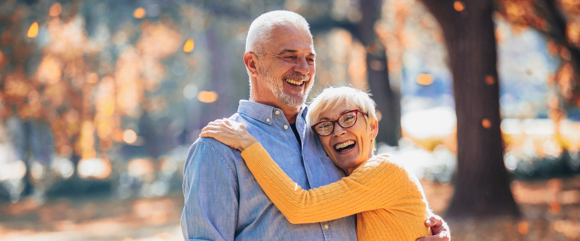 Active seniors on a walk in autumn forest