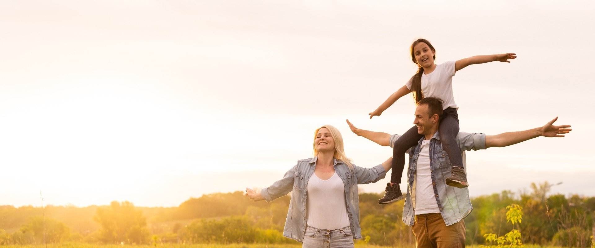 Young happy family in a field